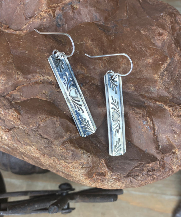 Long silver drop with heart pattern earrings