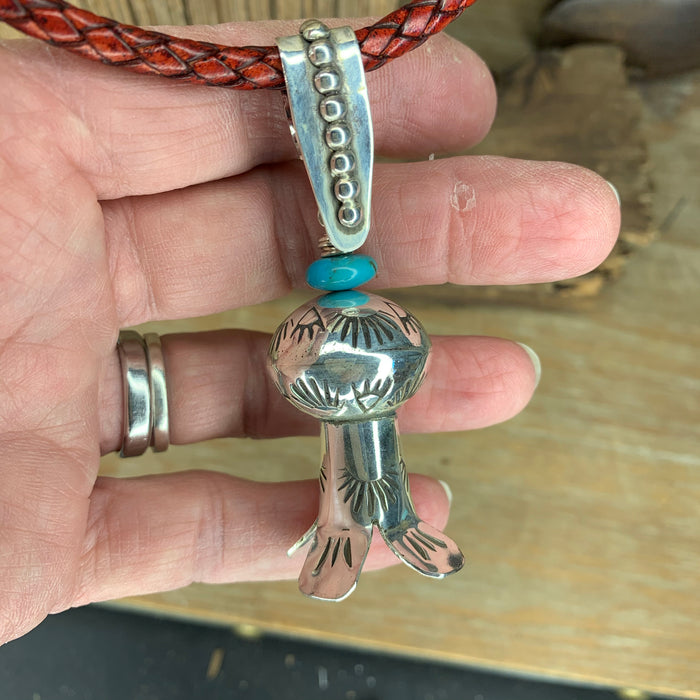 Squash blossom pendant on a braided leather chain