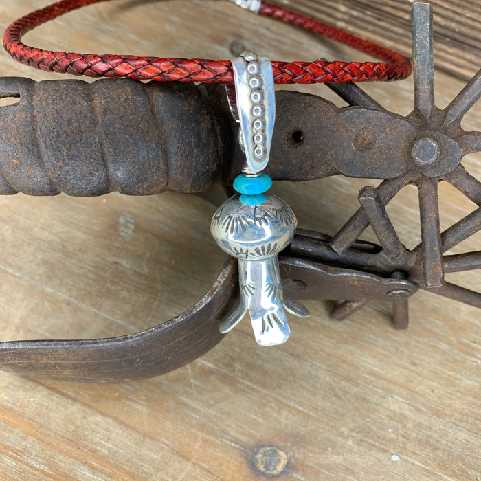 Squash blossom pendant on a braided leather chain