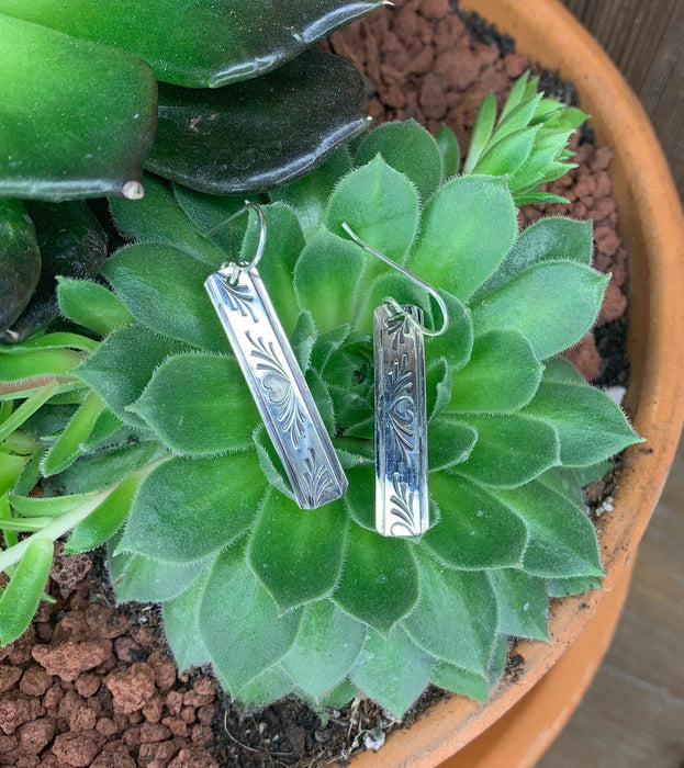 Long silver drop with heart pattern earrings