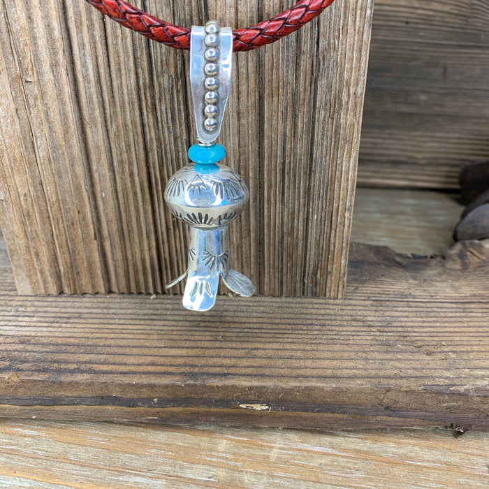 Squash blossom pendant on a braided leather chain